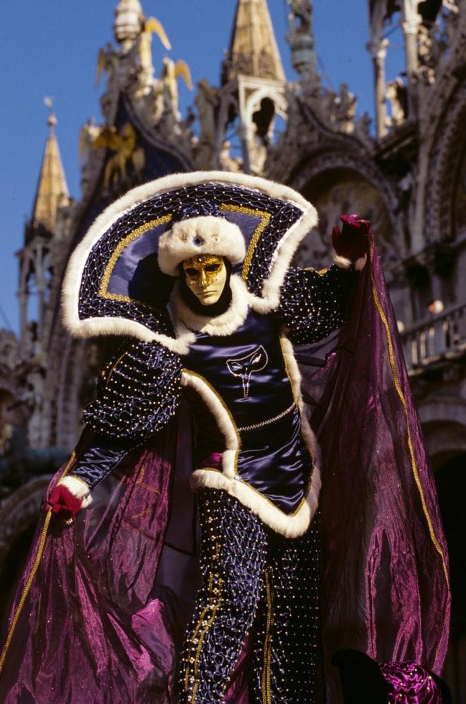 Ro literary travelers, a reveler poses on a balustrade during the Carnevale di Venezia © 1999 Charles & Mary Love